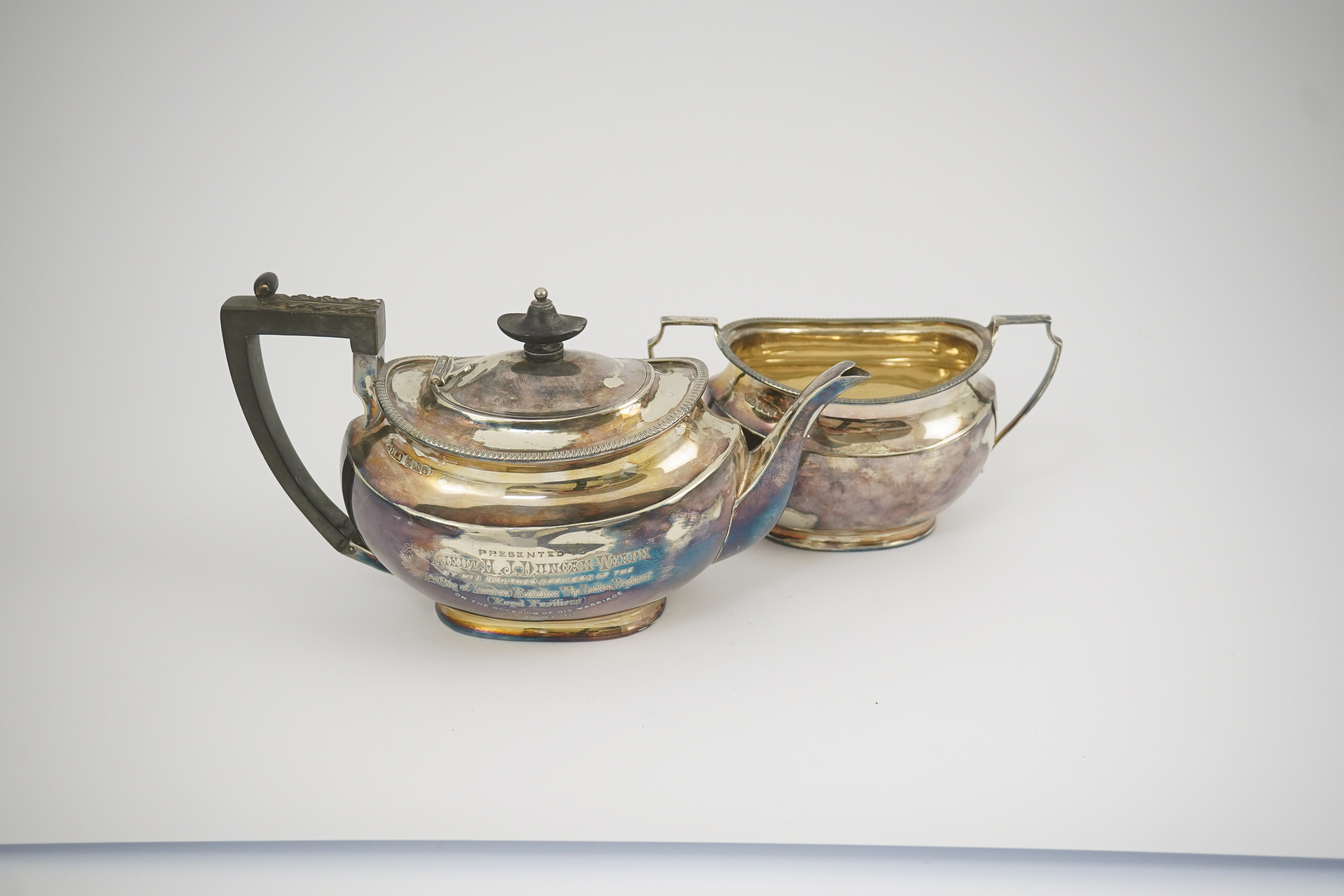 An Edwardian silver teapot and a matching sugar bowl, with engraved inscription, relating to the Royal Fusiliers, by Atkin Brothers